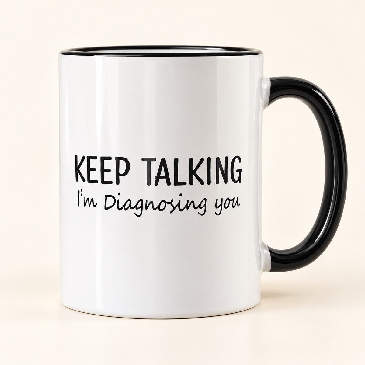 White coffee mug that reads Keep Talking, I'm Diagnosing You, with black handle